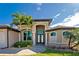 Front view of the house, showing the entryway and landscaping at 849 Rotonda Cir, Rotonda West, FL 33947