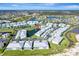 Aerial view of a condo community with pool and lake at 5760 Sabal Trace Dr # 202, North Port, FL 34287