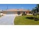 Single-story home with two-car garage and well-maintained lawn at 976 Euclid Rd, Venice, FL 34293