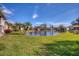 Serene pond view, lush green grass and palm trees at 514 Pine Hollow Cir # 514, Englewood, FL 34223