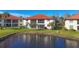 Condo building with pond view and lush landscaping at 514 Pine Hollow Cir # 514, Englewood, FL 34223