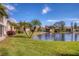 Peaceful pond-side view with tropical landscaping at 514 Pine Hollow Cir # 514, Englewood, FL 34223