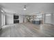 Open living room and kitchen with grey flooring at 19196 Raymond Ave, Port Charlotte, FL 33954