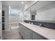 Spa-like bathroom with double vanity, a walk-in shower, and grey cabinets at 19196 Raymond Ave, Port Charlotte, FL 33954