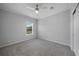 Bright bedroom with gray carpeting and ceiling fan at 19196 Raymond Ave, Port Charlotte, FL 33954