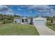 Single-story home with attached garage and grassy yard at 19196 Raymond Ave, Port Charlotte, FL 33954