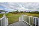 Open backyard with grassy area and deck at 19196 Raymond Ave, Port Charlotte, FL 33954