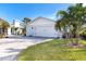 Detached garage with paver driveway and lush landscaping at 915 Allen Ave, Englewood, FL 34223