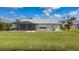 Screened patio and grassy backyard overlooking a canal at 254 Bunker Rd, Rotonda West, FL 33947