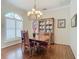 Bright dining room features hardwood floors, a chandelier, and built-in hutch at 254 Bunker Rd, Rotonda West, FL 33947