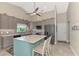 Modern kitchen with gray cabinets, a large island, and stainless steel appliances at 264 Park Forest Blvd, Englewood, FL 34223