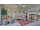 Spacious living room featuring a comfortable couch and large TV at 19 Quails Run Blvd # 2, Englewood, FL 34223