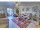 Living room with beige couch and access to a screened-in patio at 19 Quails Run Blvd # 2, Englewood, FL 34223