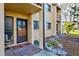 Condo entryway with a private door and small patio area at 19 Quails Run Blvd # 2, Englewood, FL 34223