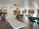 Community room with tables, chairs, and bookcases at 19 Quails Run Blvd # 2, Englewood, FL 34223