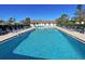 Inviting community pool with lounge chairs and shaded seating area at 19 Quails Run Blvd # 2, Englewood, FL 34223
