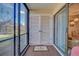 Covered patio with access to the backyard and additional storage at 19 Quails Run Blvd # 2, Englewood, FL 34223
