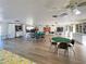 Bright community room with multiple tables and chairs at 19 Quails Run Blvd # 2, Englewood, FL 34223