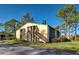 Two-story condo building with a wood staircase and screened-in patio at 19 Quails Run Blvd # 2, Englewood, FL 34223