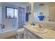 Clean bathroom with a tub, toilet and vanity at 19 Quails Run Blvd # 2, Englewood, FL 34223