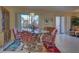 Casual dining area with glass table and access to a screened-in patio at 19 Quails Run Blvd # 2, Englewood, FL 34223