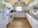 Kitchen with white cabinets, granite counters, and appliances at 19 Quails Run Blvd # 2, Englewood, FL 34223