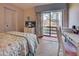 Bright bedroom with built-in desk and access to a private patio at 19 Quails Run Blvd # 2, Englewood, FL 34223