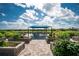 Community garden with raised garden beds and shaded seating at 13077 Rinella St, Venice, FL 34293