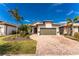 Single-story home with a two-car garage and landscaped front yard at 13077 Rinella St, Venice, FL 34293
