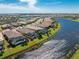 Aerial view of home with pool and canal views at 13077 Rinella St, Venice, FL 34293