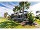 Landscaped backyard featuring a screened pool and lush greenery at 13077 Rinella St, Venice, FL 34293