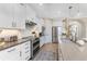 Modern kitchen with white cabinets, stainless steel appliances and a large island at 13077 Rinella St, Venice, FL 34293