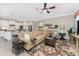 Tan sectional sofa, decorative rug, and ceiling fan in the living room at 13077 Rinella St, Venice, FL 34293