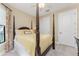 Serene bedroom with a four-poster bed, ample natural light, and a ceiling fan at 13077 Rinella St, Venice, FL 34293