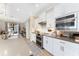 Modern kitchen with white cabinets, stainless steel appliances and a large island at 13077 Rinella St, Venice, FL 34293
