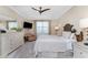Spacious bedroom with king-size bed, dresser, and seating area at 13077 Rinella St, Venice, FL 34293