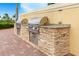 Outdoor grilling station with stone facade and stainless steel grills at 13077 Rinella St, Venice, FL 34293