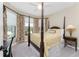 Bright bedroom featuring a comfortable four-poster bed and plenty of natural light at 13077 Rinella St, Venice, FL 34293