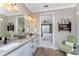 Double vanity bathroom with a view into the bedroom and a glass shower at 13077 Rinella St, Venice, FL 34293