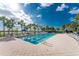 Community lap pool with lounge chairs and palm trees at 13077 Rinella St, Venice, FL 34293