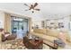 Living room with a comfortable sectional sofa and access to a backyard patio at 13077 Rinella St, Venice, FL 34293