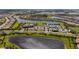 Aerial view of community, including lake, homes, and amenities at 13077 Rinella St, Venice, FL 34293