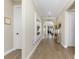 Long hallway with hardwood floors and a large mirror at 13077 Rinella St, Venice, FL 34293