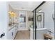 Bathroom with double vanity, large shower, and view into bedroom at 13077 Rinella St, Venice, FL 34293