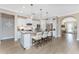 Modern kitchen with white cabinets, a large island, and stainless steel appliances at 13077 Rinella St, Venice, FL 34293