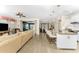 Open floor plan with kitchen island, stainless steel appliances, and spacious living area at 13077 Rinella St, Venice, FL 34293
