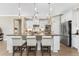 Modern kitchen with white cabinets, a large island, and stainless steel appliances at 13077 Rinella St, Venice, FL 34293