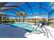 Inviting pool and spa with a screened enclosure, overlooking a tranquil landscape at 13077 Rinella St, Venice, FL 34293