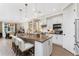 Modern kitchen with white cabinets, large island, and stainless steel appliances at 13077 Rinella St, Venice, FL 34293