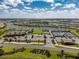 Aerial view of community with lake, pool, tennis courts, and playground at 13077 Rinella St, Venice, FL 34293